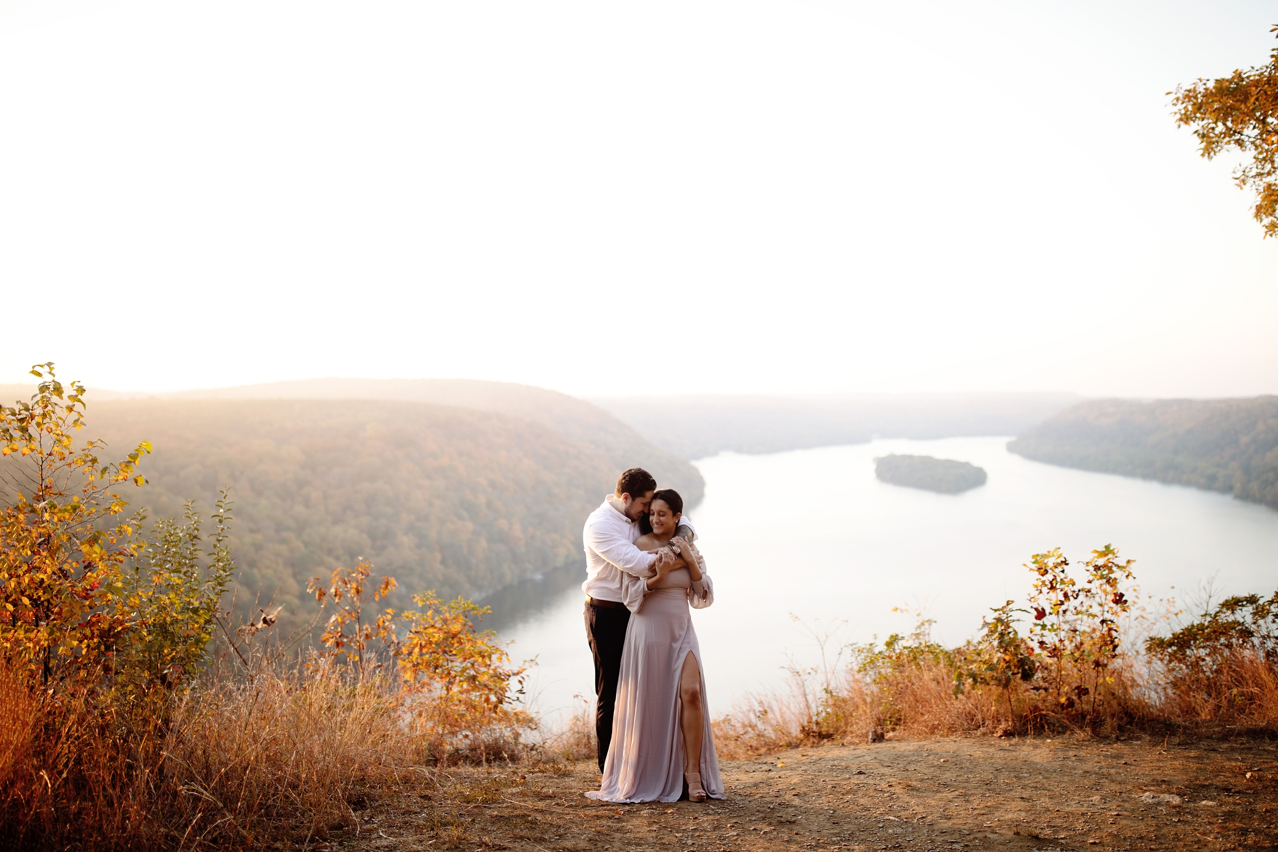 Romantic golden hour engagement photo session at The Pinnacle Overlook in Lancaster, PA. River overlook with bride wearing an off the shoulder lavender gown.