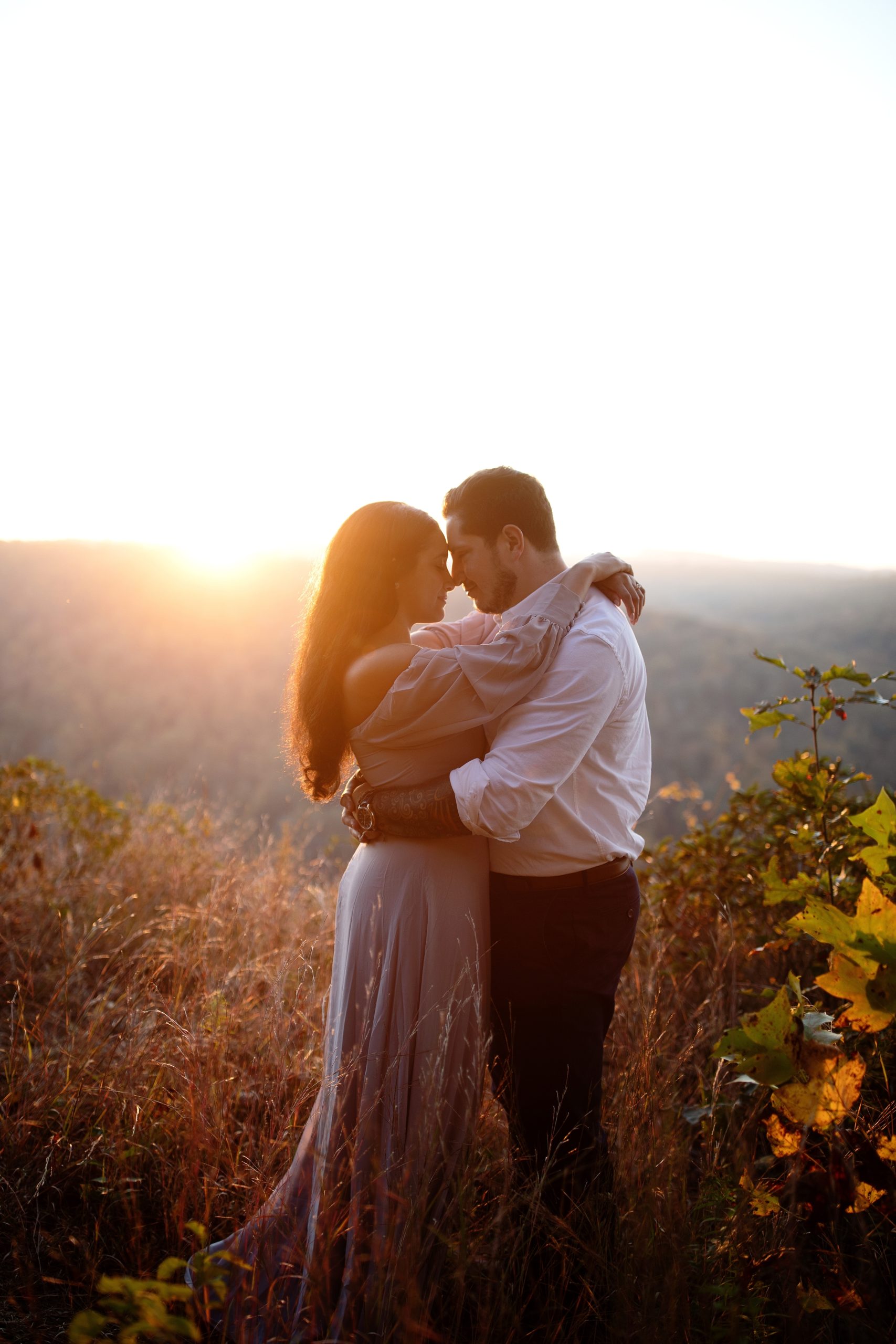 Romantic golden hour engagement photo session at The Pinnacle Overlook in Lancaster, PA. River overlook with bride wearing an off the shoulder lavender gown.